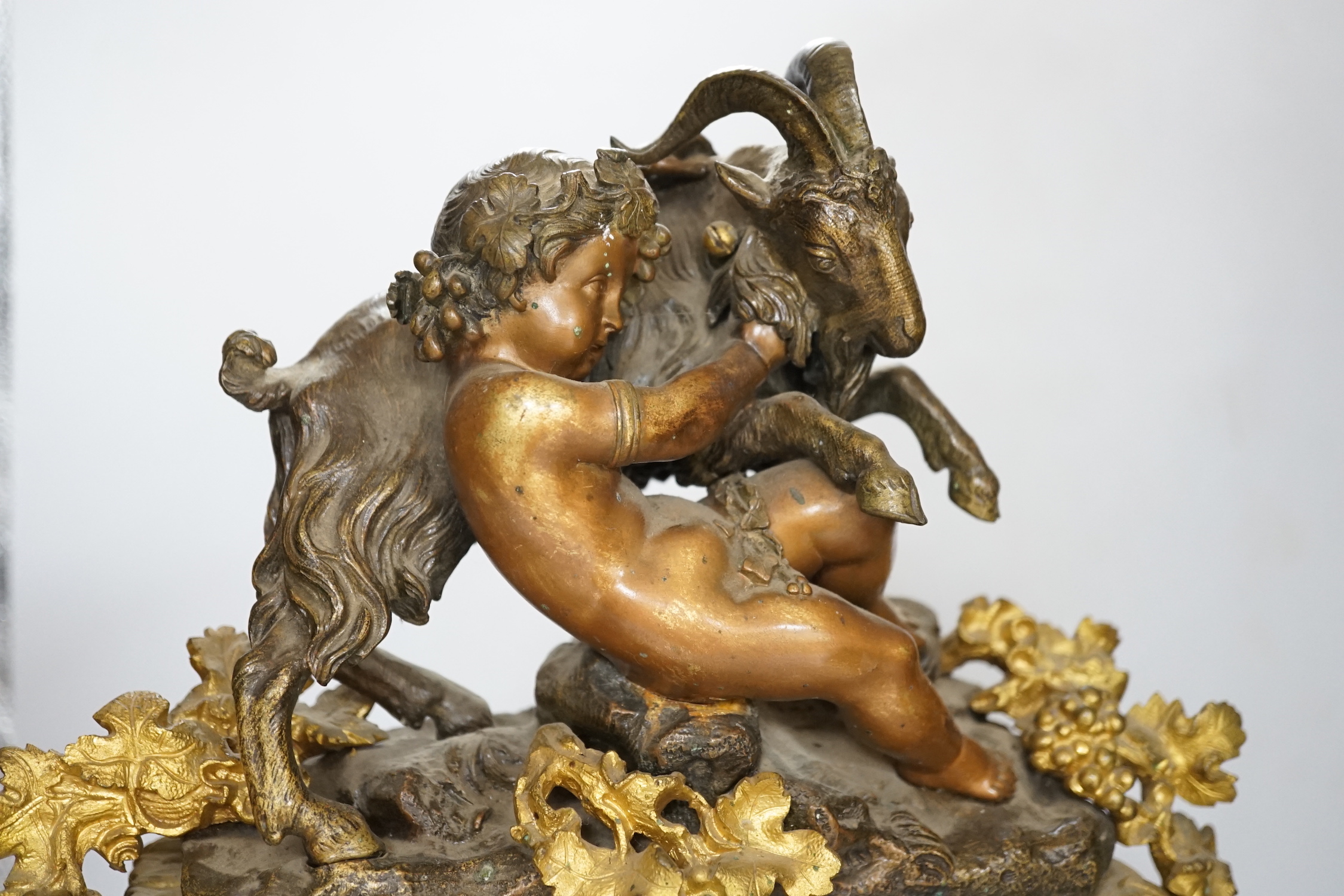 An early 20th century gilt-metal mounted mantel clock with bacchanalian group surmount, 44cm
